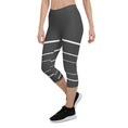 Load image into Gallery viewer, Elevate your wardrobe with these Elevated Essence Capris, the perfect addition to your athleisure collection. These capris feature a sleek and stylish design with white horizontal lines on a dark grey base, creating a striking yet versatile look that can be dressed up or down. The four-way stretch fabric ensures a comfortable and flexible fit, while the high-rise waistband offers support and coverage.