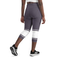 Load image into Gallery viewer, Indulge in sweet dreams with Lavender Dreams yoga capri leggings. These leggings boast a delightful lavender color with eye-catching white banding. Perfect for yoga, the gym, or casual wear, these leggings offer a flattering fit and superior comfort that will make them your go-to choice.