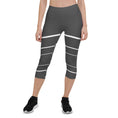 Load image into Gallery viewer, Elevate your wardrobe with these Elevated Essence Capris, the perfect addition to your athleisure collection. These capris feature a sleek and stylish design with white horizontal lines on a dark grey base, creating a striking yet versatile look that can be dressed up or down. The four-way stretch fabric ensures a comfortable and flexible fit, while the high-rise waistband offers support and coverage.
