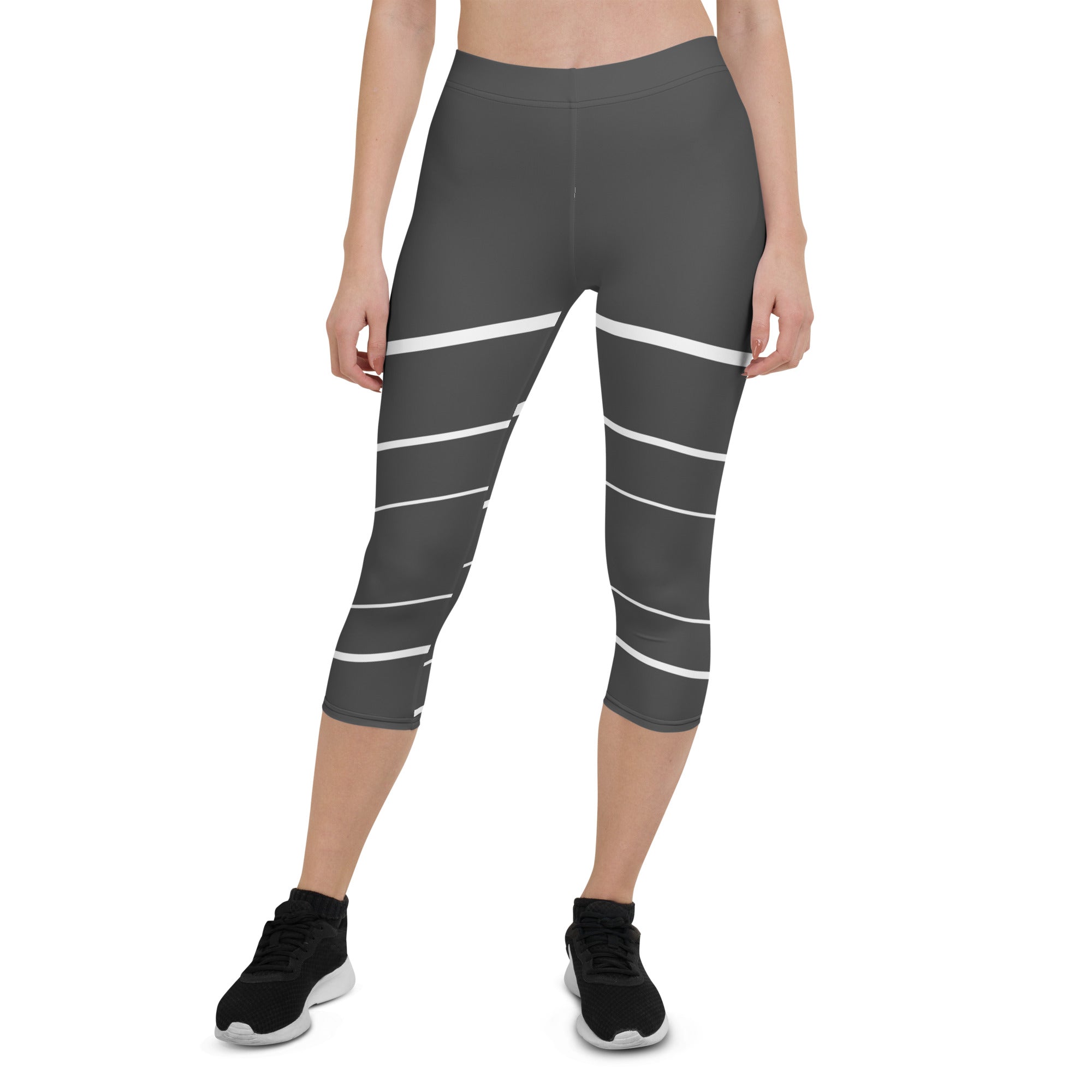 Elevate your wardrobe with these Elevated Essence Capris, the perfect addition to your athleisure collection. These capris feature a sleek and stylish design with white horizontal lines on a dark grey base, creating a striking yet versatile look that can be dressed up or down. The four-way stretch fabric ensures a comfortable and flexible fit, while the high-rise waistband offers support and coverage.