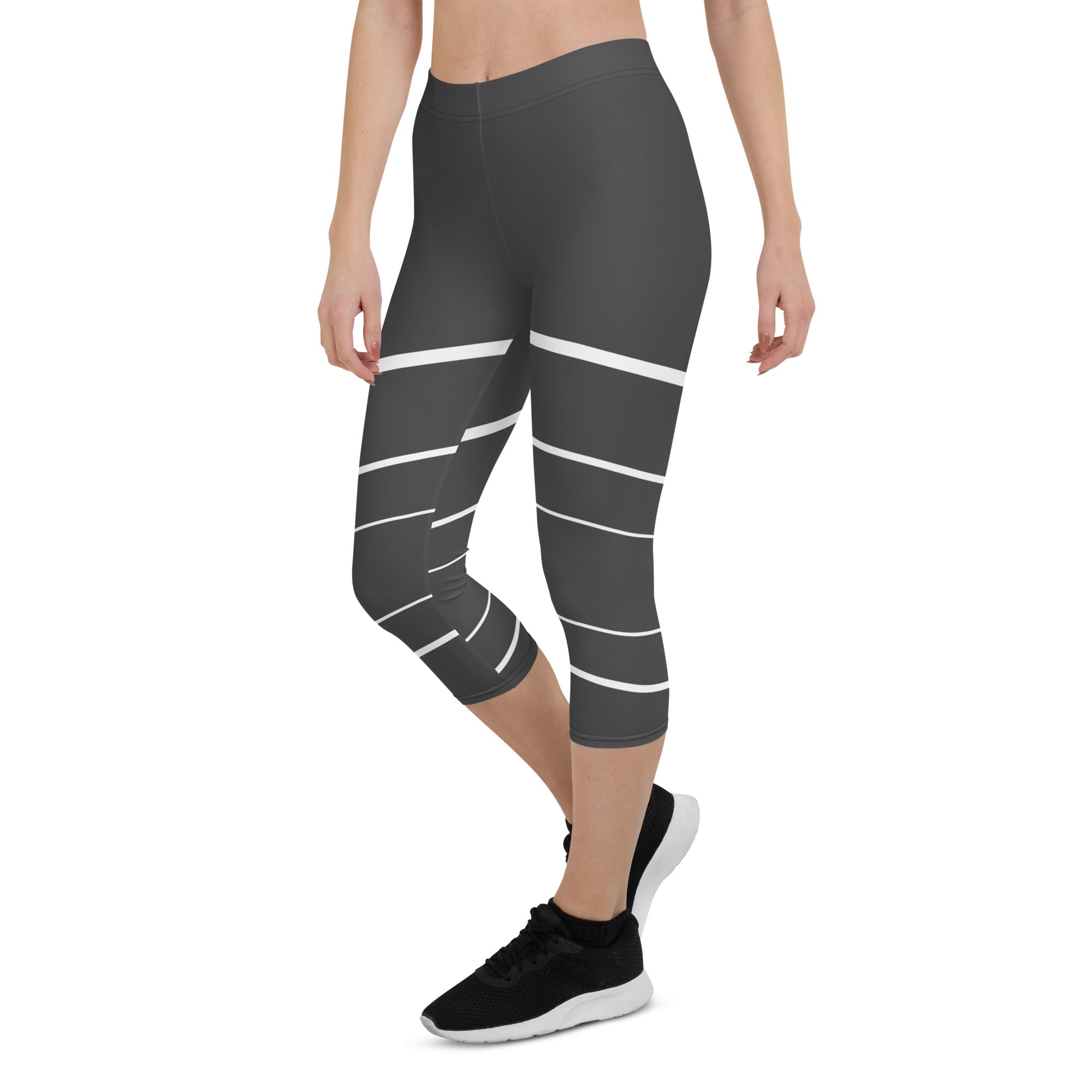 Elevate your wardrobe with these Elevated Essence Capris, the perfect addition to your athleisure collection. These capris feature a sleek and stylish design with white horizontal lines on a dark grey base, creating a striking yet versatile look that can be dressed up or down. The four-way stretch fabric ensures a comfortable and flexible fit, while the high-rise waistband offers support and coverage.