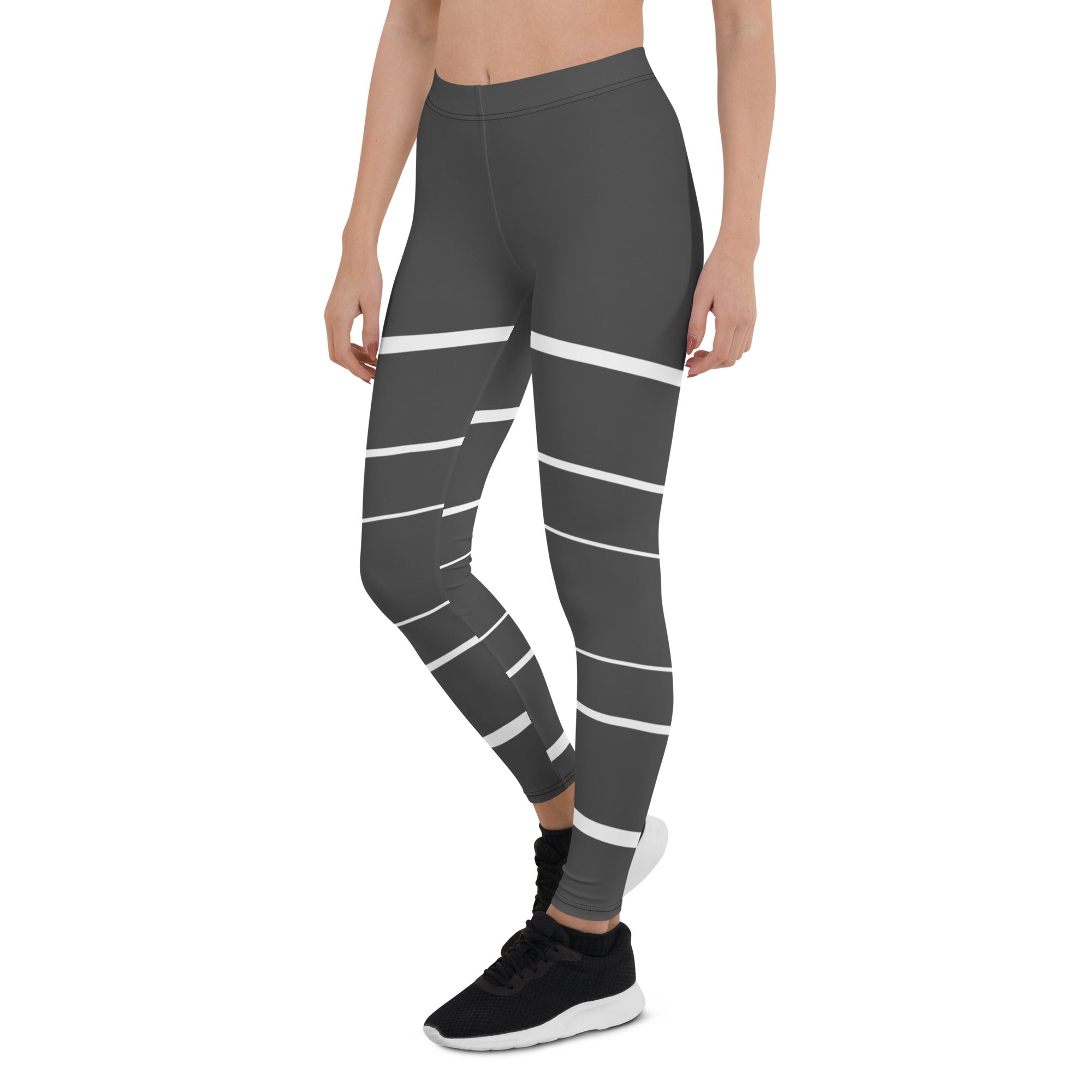 Elevate your daily style with these versatile and comfortable leggings. The unique white lines against the dark grey background make a bold statement that's perfect for any occasion. From yoga classes to brunch with friends or a night out on the town, these leggings will keep you looking and feeling your best. 