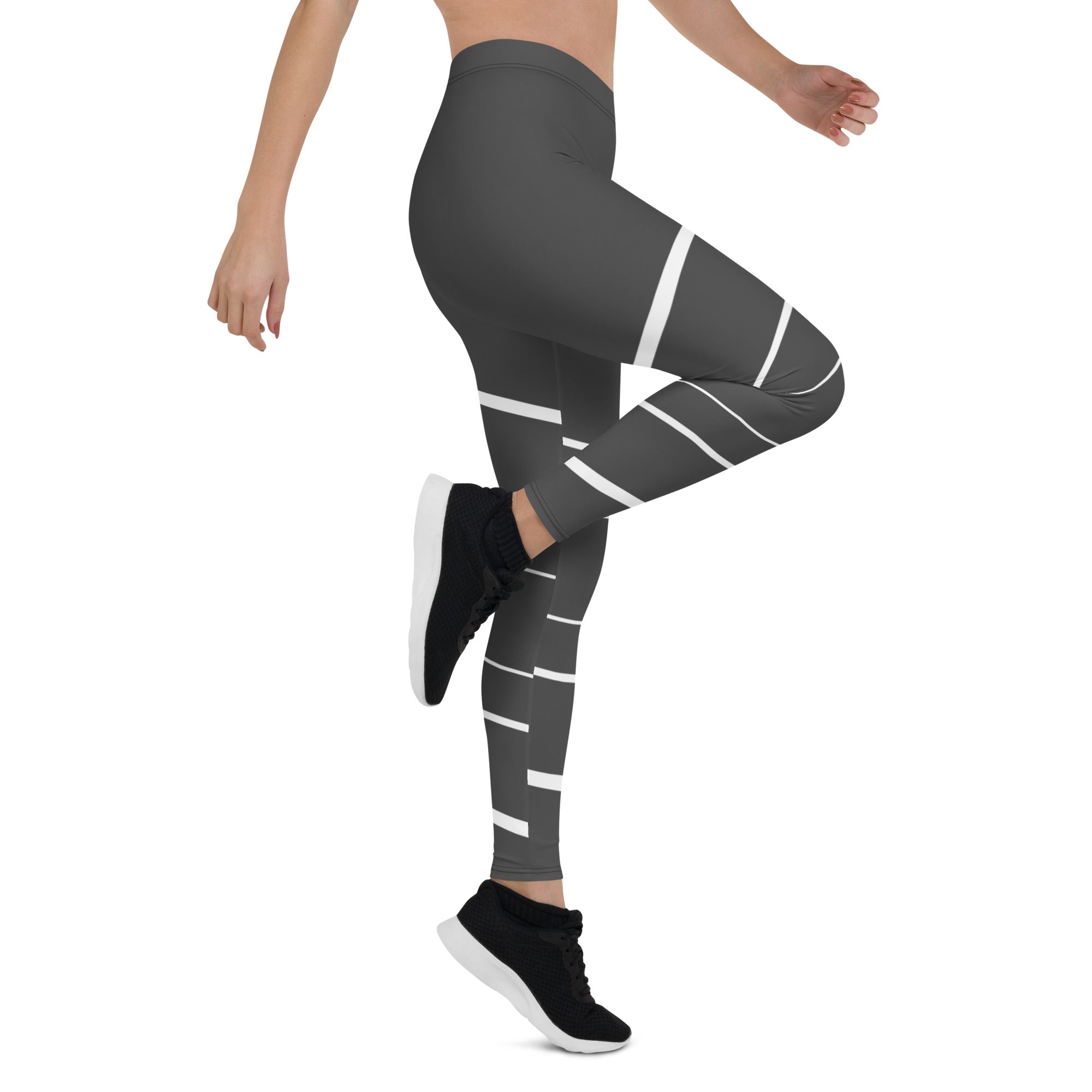 Elevate your daily style with these versatile and comfortable leggings. The unique white lines against the dark grey background make a bold statement that's perfect for any occasion. From yoga classes to brunch with friends or a night out on the town, these leggings will keep you looking and feeling your best. 