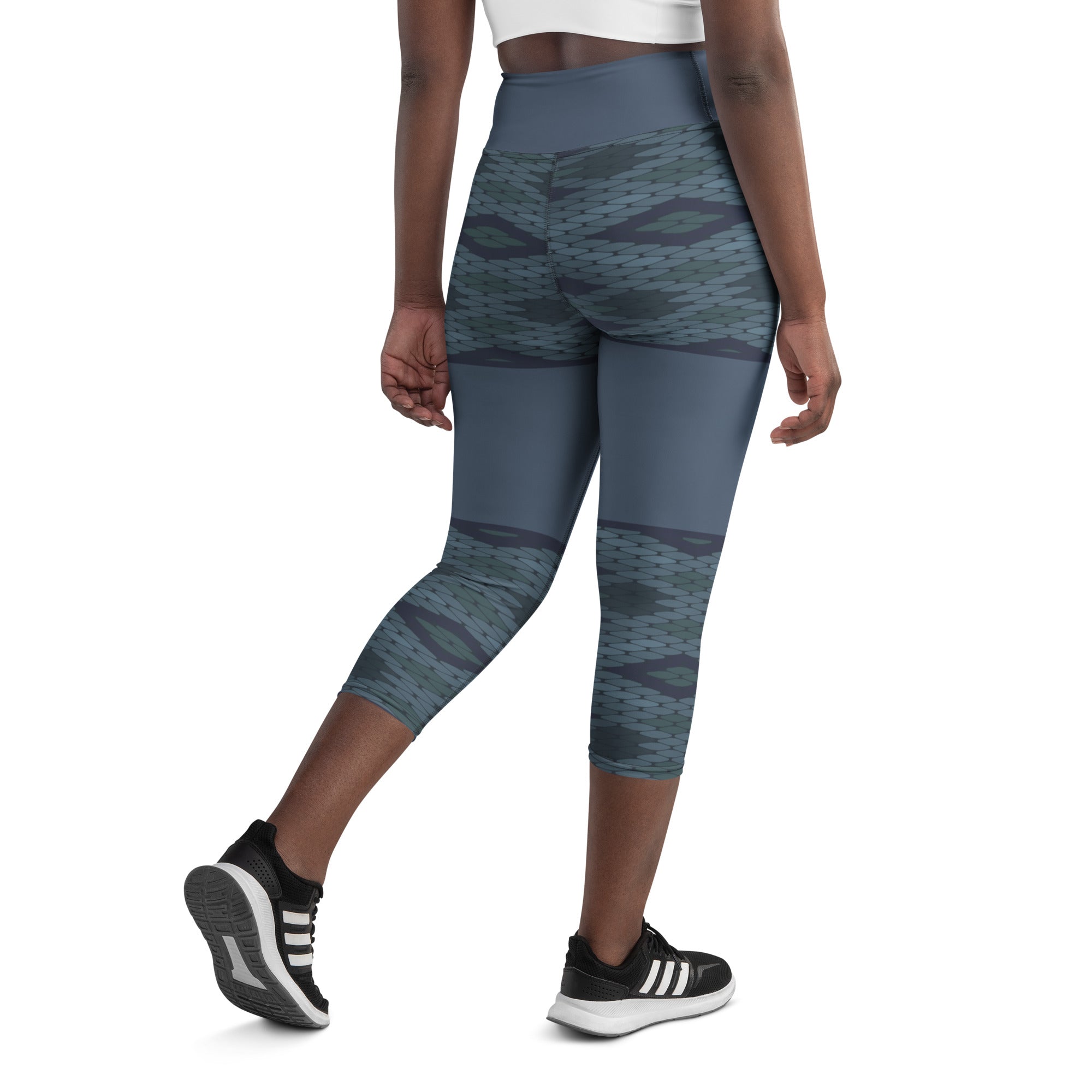 Looking for a pair of yoga capris that are both comfortable and stylish? Look no further than Blue Prism! Featuring a high, elastic waistband and a unique diamond scale pattern in various shades of blue, these capris provide a flattering fit and easy movement for any workout or lounging session.