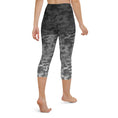 Load image into Gallery viewer, Introducing our Stealth Yoga Capri Leggings, the perfect blend of style, comfort, and performance. These leggings feature a unique camouflage gradient pattern, designed to make a statement while providing the versatility you need for any workout.
