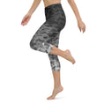 Load image into Gallery viewer, Introducing our Stealth Yoga Capri Leggings, the perfect blend of style, comfort, and performance. These leggings feature a unique camouflage gradient pattern, designed to make a statement while providing the versatility you need for any workout.
