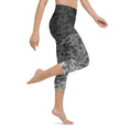 Load image into Gallery viewer, Introducing our Stealth Yoga Capri Leggings, the perfect blend of style, comfort, and performance. These leggings feature a unique camouflage gradient pattern, designed to make a statement while providing the versatility you need for any workout.
