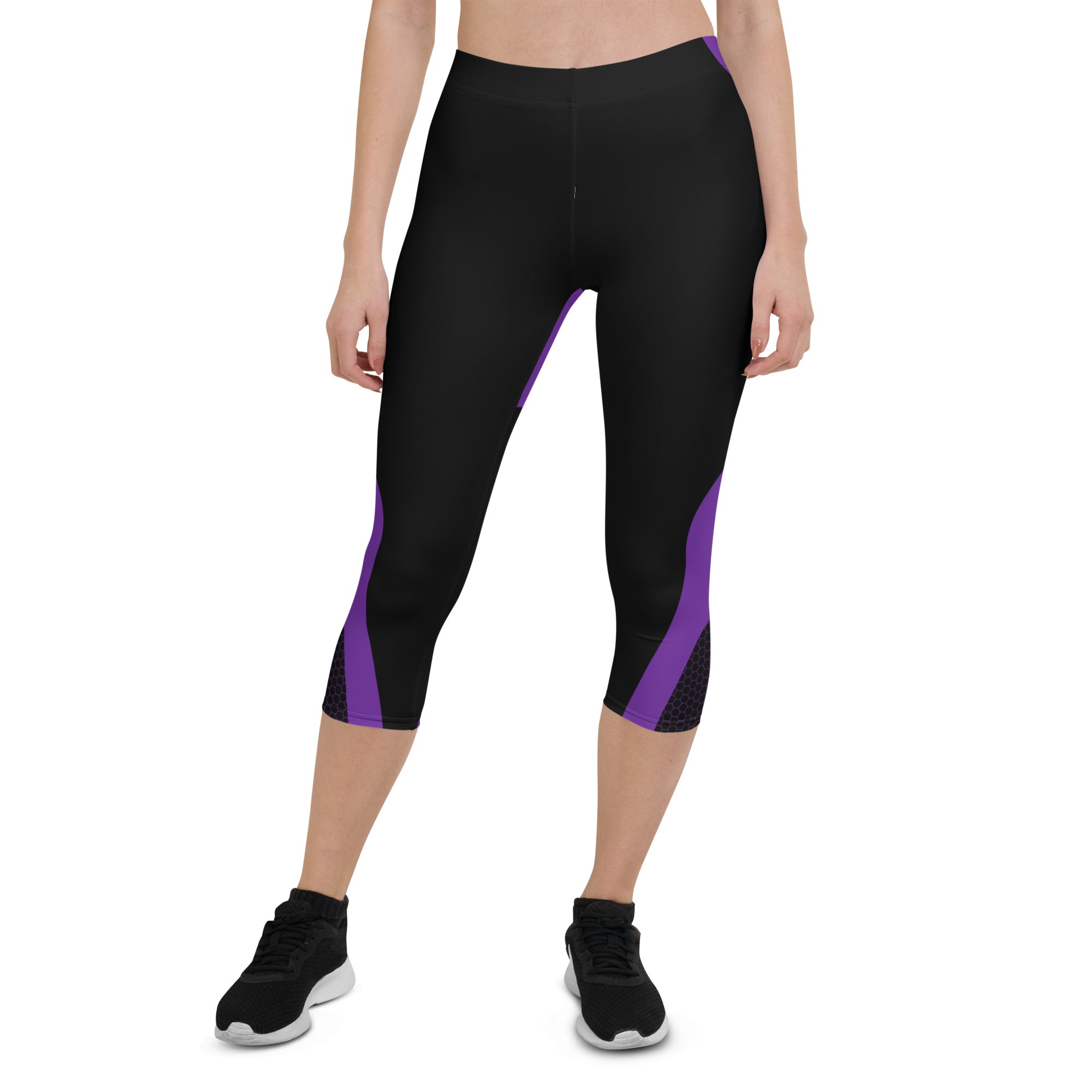 Indulge in the ultimate comfort with our Midnight Hex Capri Leggings. These leggings feature a bold and unique design of purple curves and hexagon patterns on a sleek black background, making them perfect for any activity.