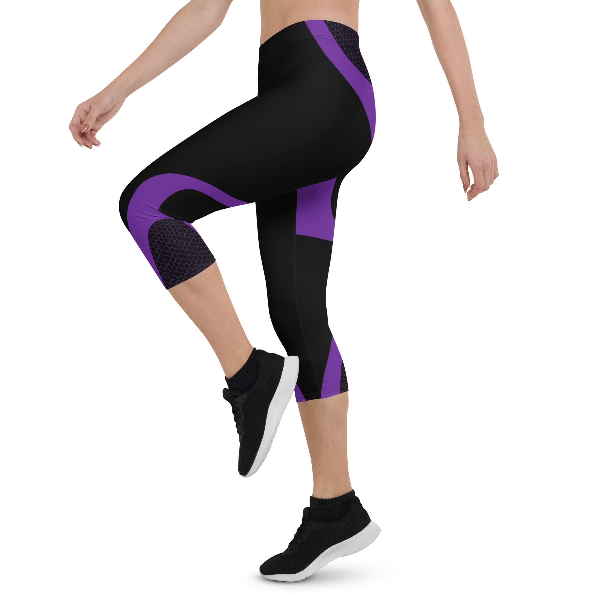 Indulge in the ultimate comfort with our Midnight Hex Capri Leggings. These leggings feature a bold and unique design of purple curves and hexagon patterns on a sleek black background, making them perfect for any activity.