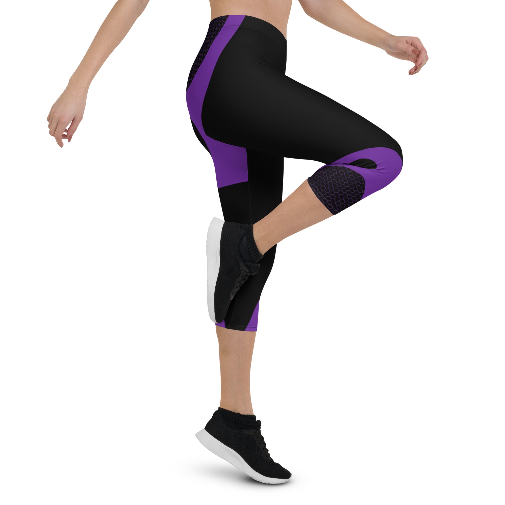 Indulge in the ultimate comfort with our Midnight Hex Capri Leggings. These leggings feature a bold and unique design of purple curves and hexagon patterns on a sleek black background, making them perfect for any activity.