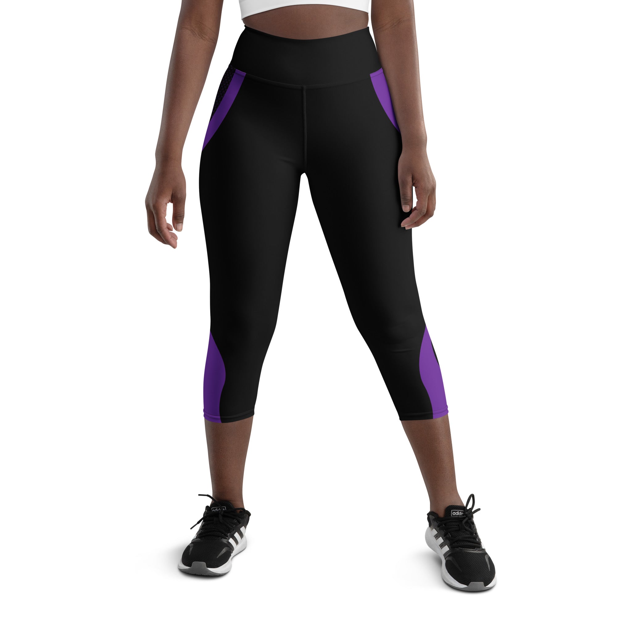 Experience comfort and style with our Midnight Hex Capri Leggings. These leggings feature a bold and unique design of purple curves and hexagon patterns on a sleek black background